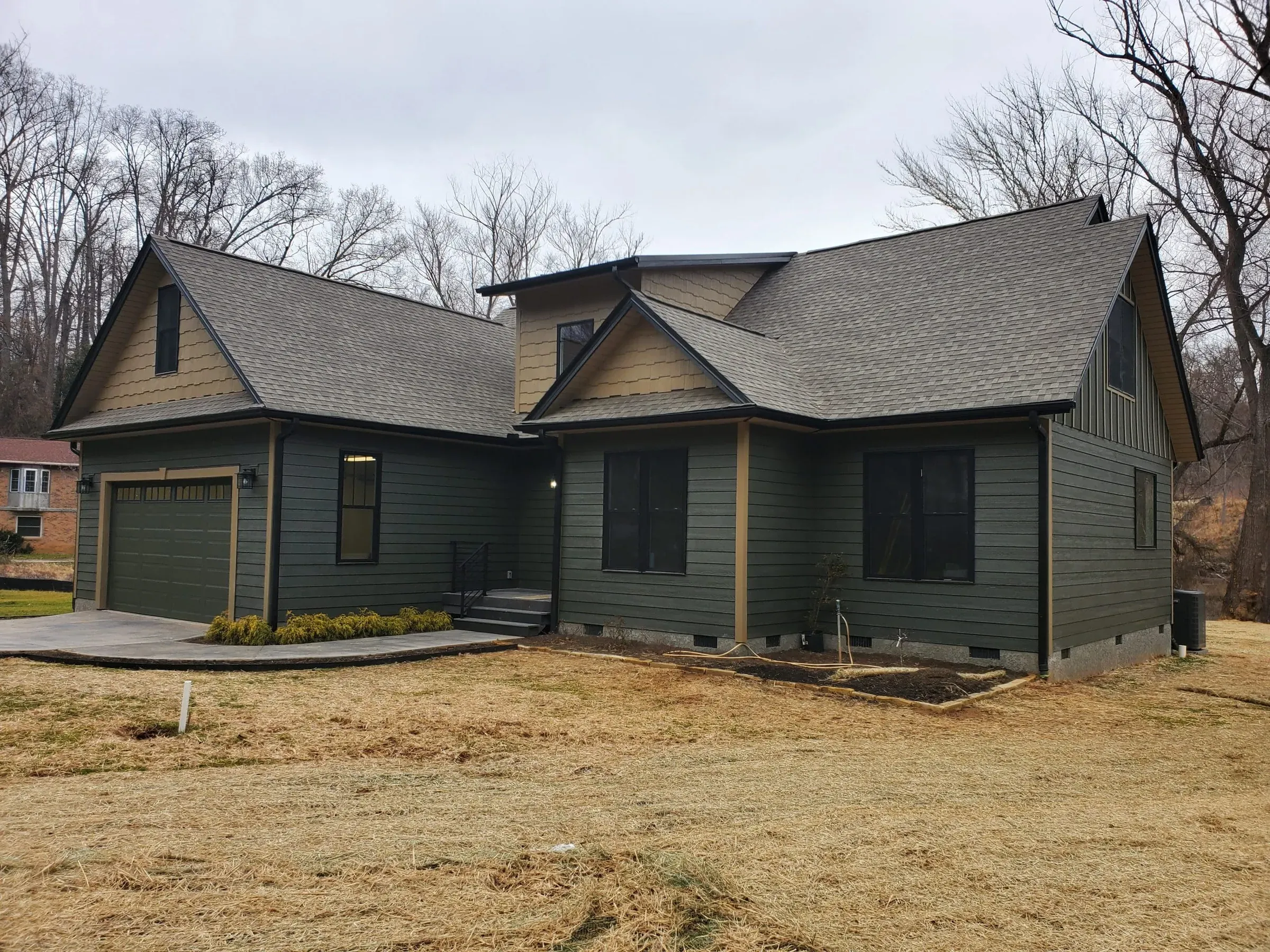New craftsman-style custom home with green siding in Candler, NC, built by Buckingham Builders