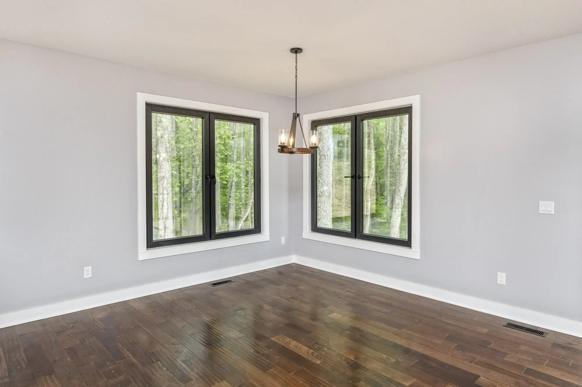 Dining room opening to the kitchen in a Weaverville, NC custom home built by Buckingham Builders