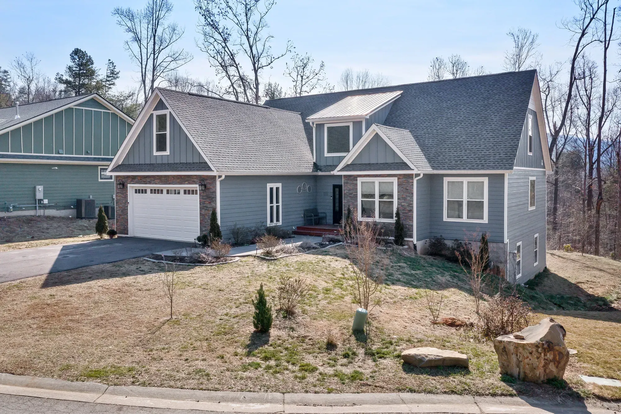 Craftsman-style custom home with blue siding and stacked-stone accents in Weaverville, NC, built by Buckingham Builders
