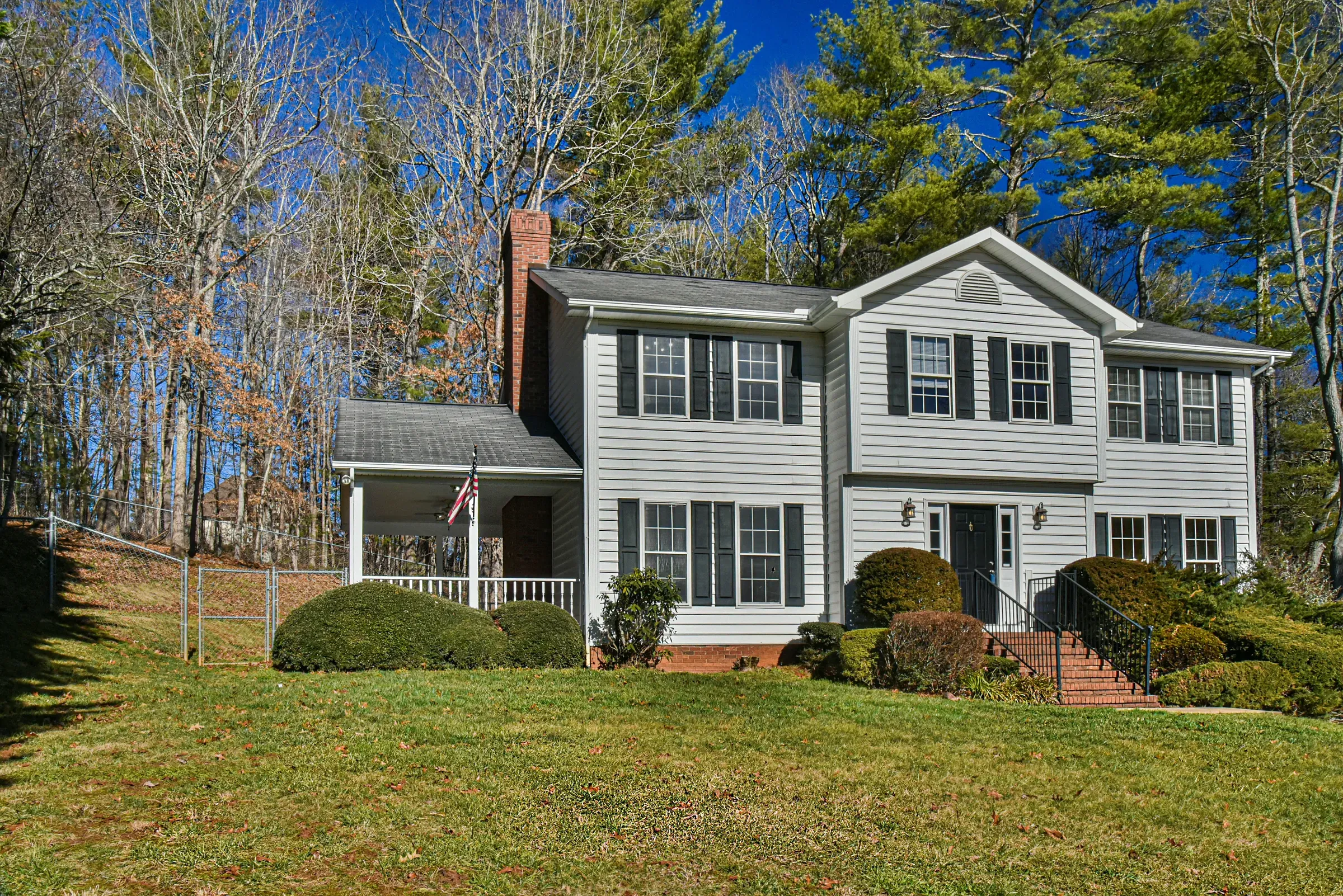 White two-story colonial custom home with front porch in Weaverville, NC, built by Buckingham Builders